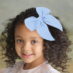 AMYDECOR sky blue fable bow on child demonstrates comfortable stylish accessory