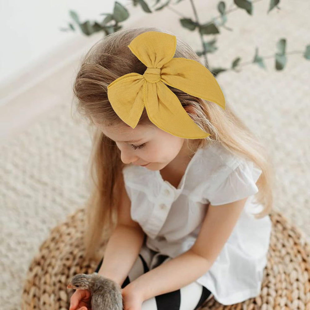 AMYDECOR Yellow Fable Bow on hair clip demonstrates secure hold for active play.