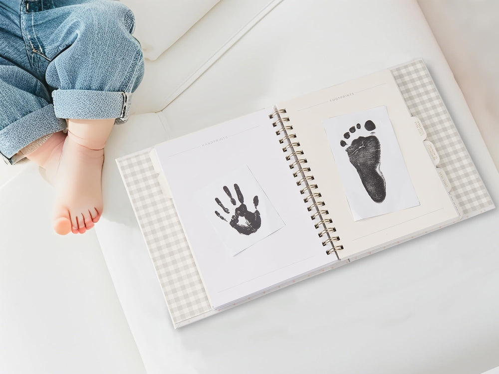 &And Per Se baby memory book features six tabbed sections for easy memory navigation.