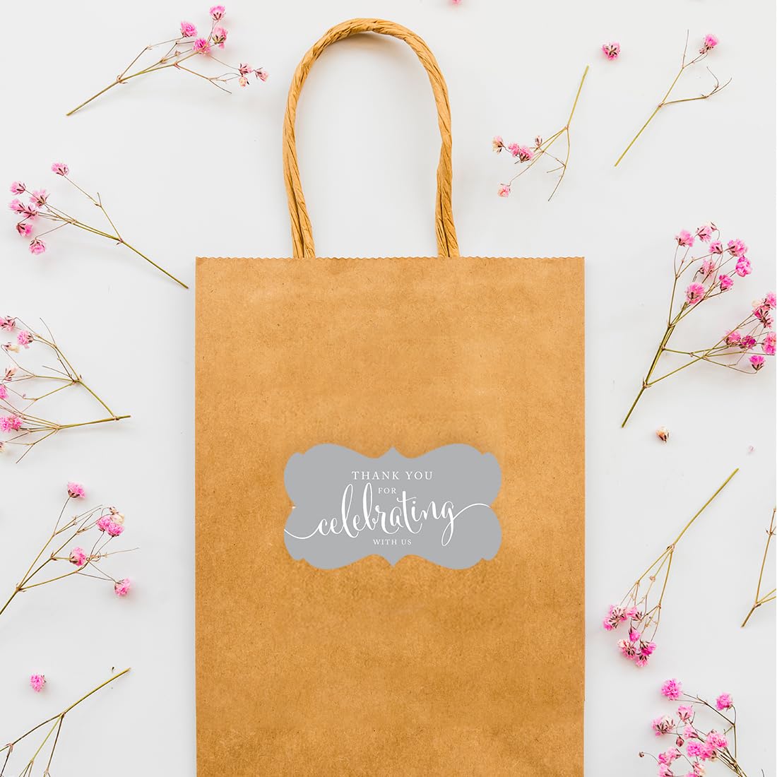 Andaz Press wedding favors stickers on gift bags create cohesive wedding-day branding