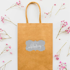 Andaz Press wedding favors stickers on gift bags create cohesive wedding-day branding