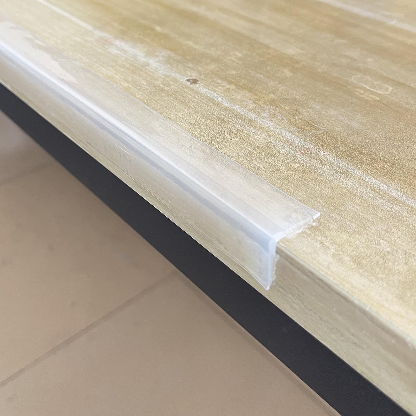 Angloria Edge Protector installed on a table corner for child safety.