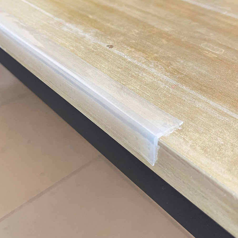 Angloria Edge Protector installed on a table corner for child safety.