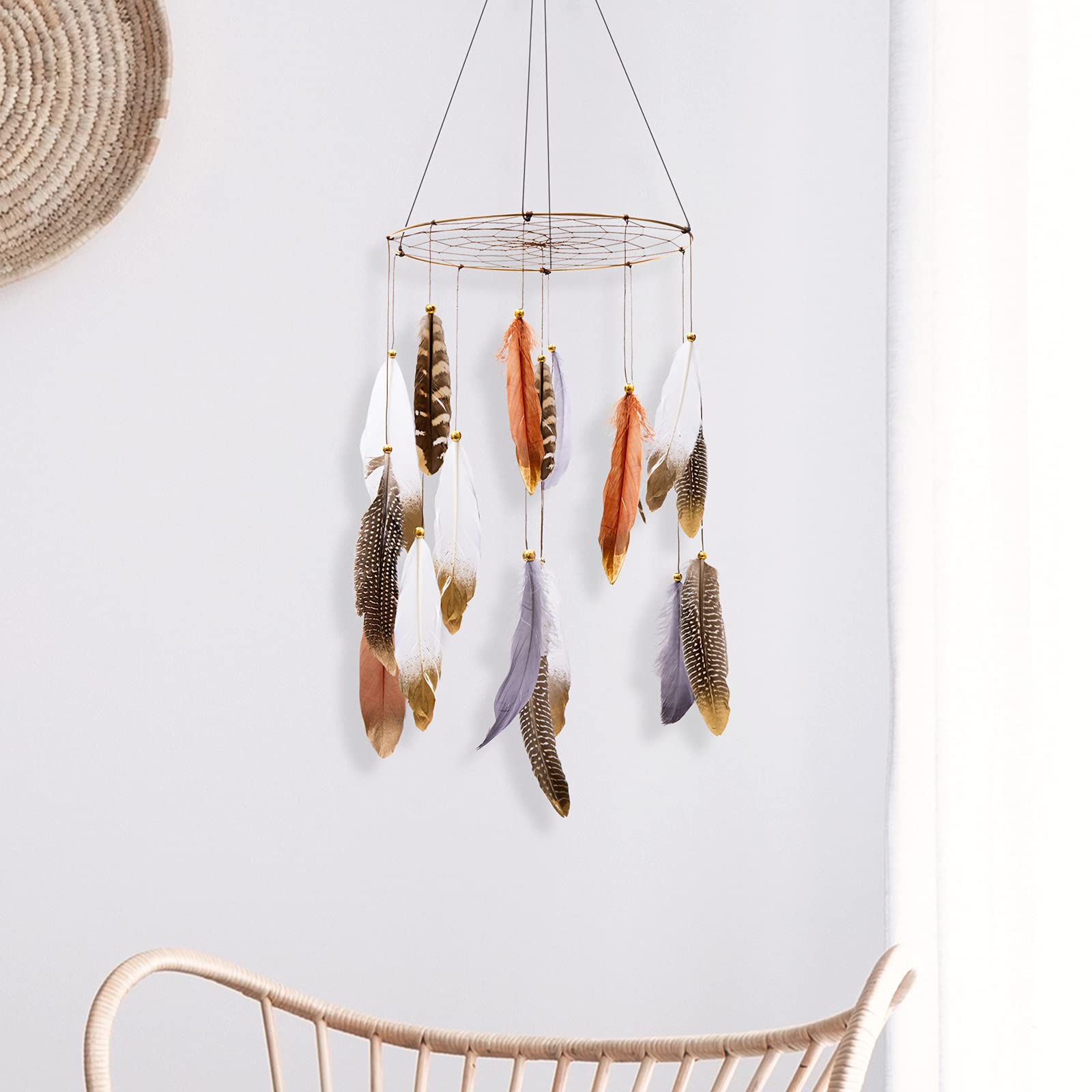 ANROYE Boho Feather Mobile hanging above crib in serene nursery for calming bedtime ambiance.
