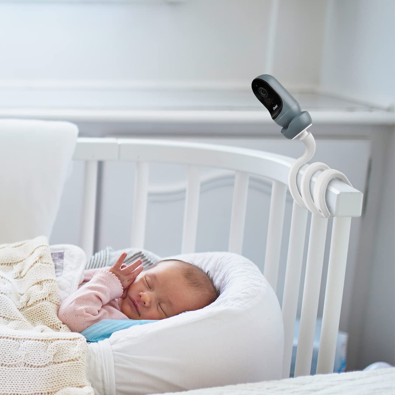 Aobelieve mount on a crib edge enables adjustable angles for over-bassinet monitoring.