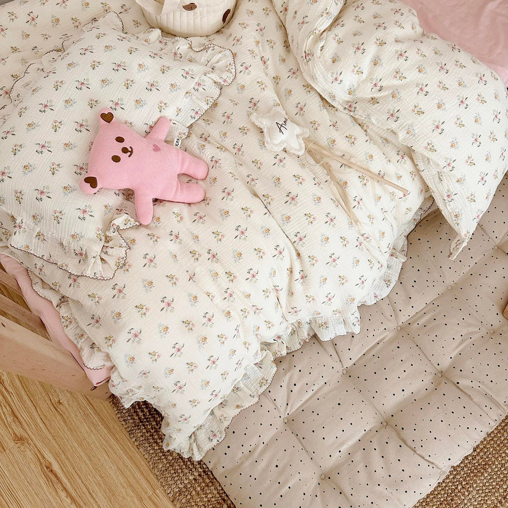 AOJIM floral print nursery decor pairs with coordinating sheets.