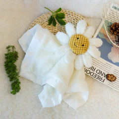 Apricot Lamb Daisy soft lovey hand-holding image demonstrates grip-friendly size for tiny fingers.
