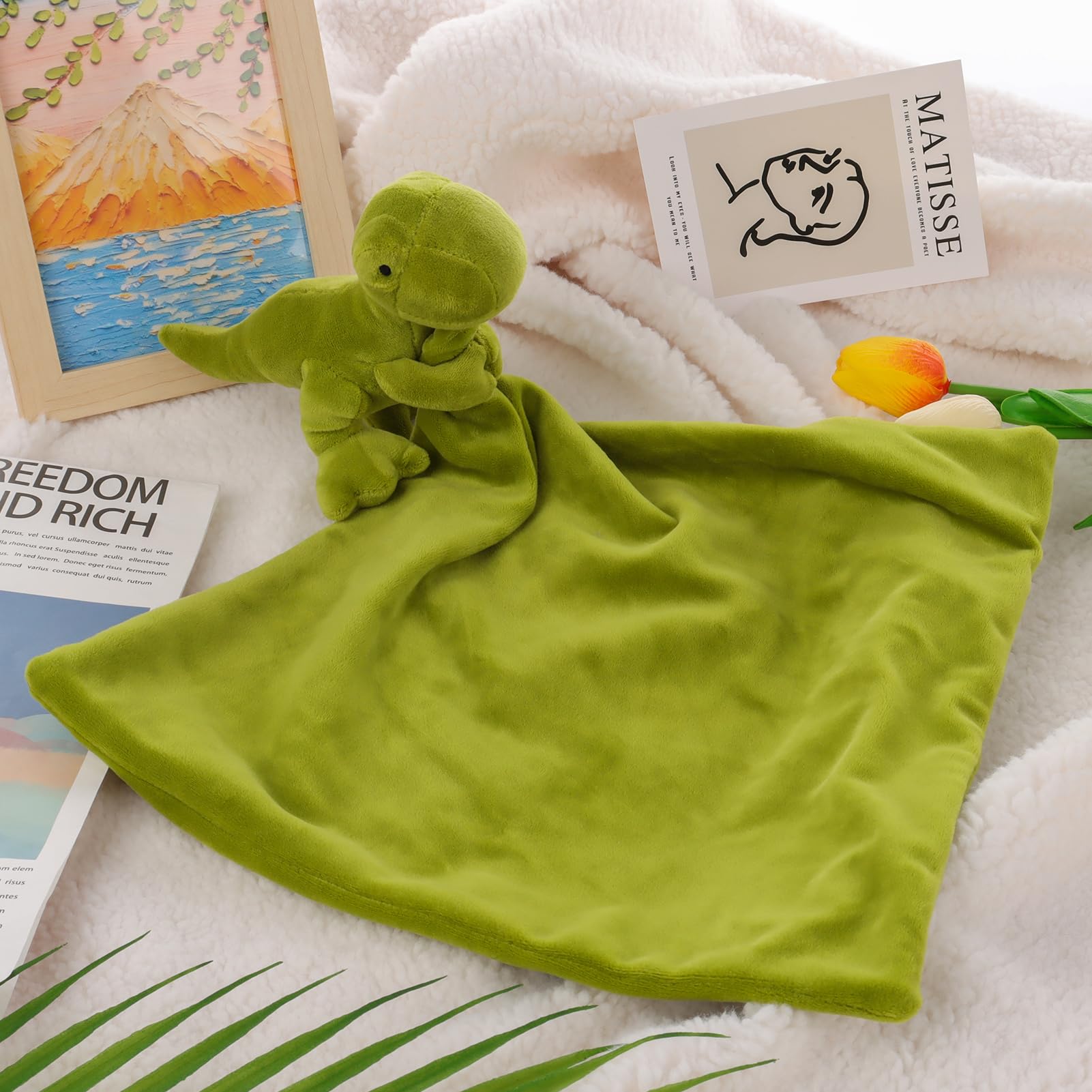 Apricot Lamb Snuggler dino security blanket provides cozy comfort for newborns