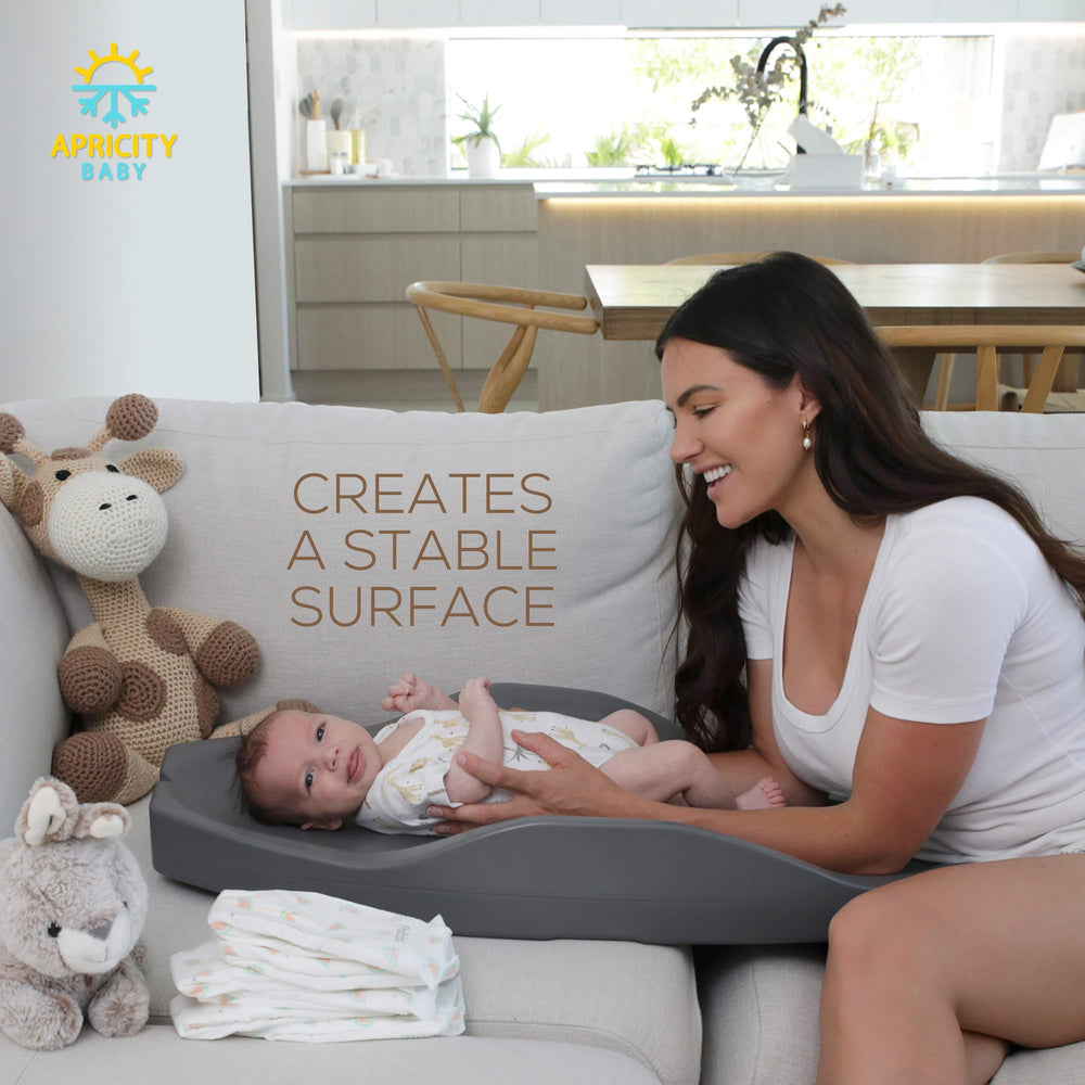 Apricity Baby diaper-changing-pad gray finish complements nursery decor.