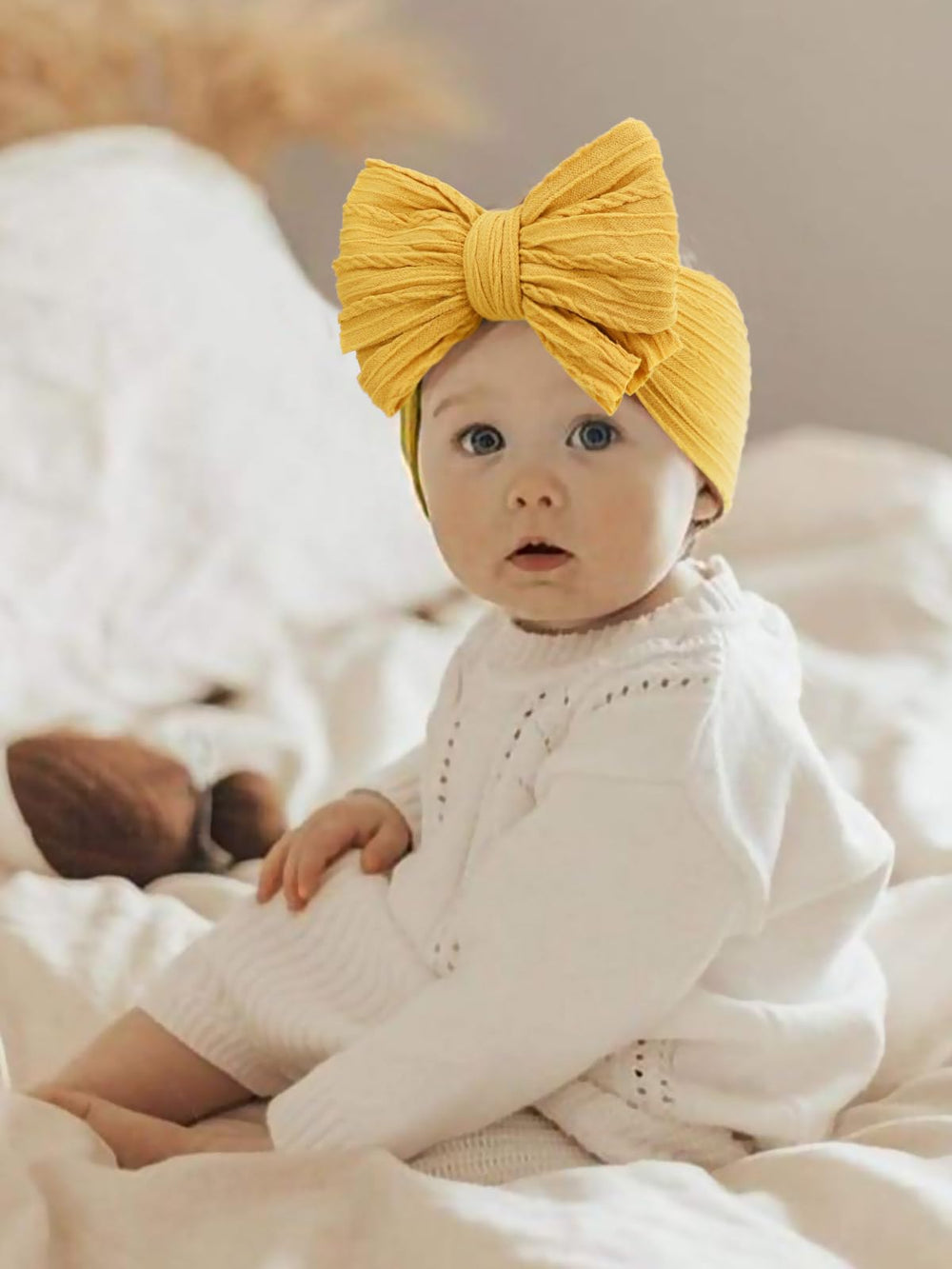 AQOKKA baby bows headbands photographed as photoshoot prop for newborns and toddlers.