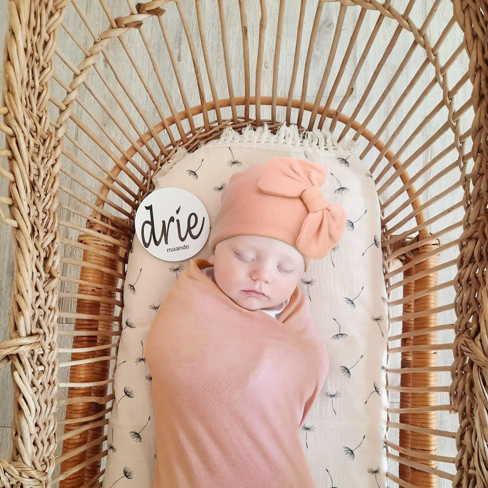 AQOKKA swaddle being used as a photo prop to capture first moments.