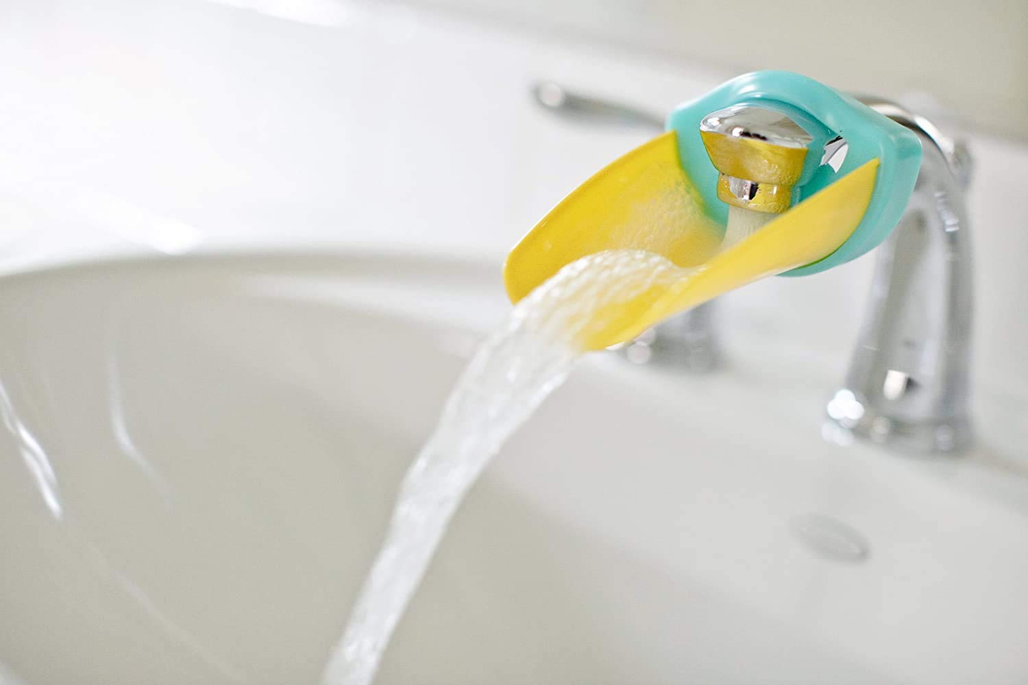 Aqueduck faucet extender attaches to most taps for easier handwashing and independent habits.