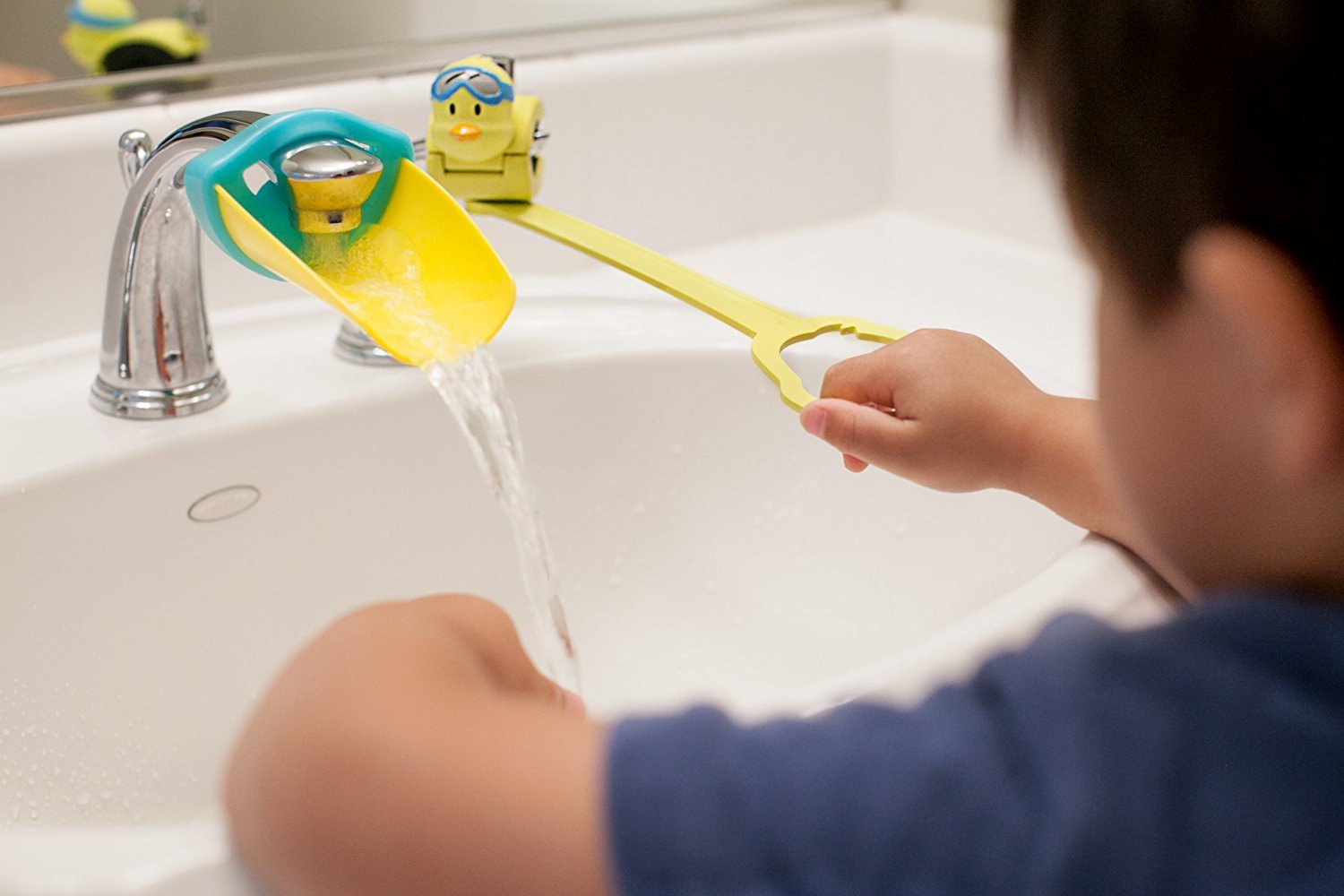 Aqueduck faucet extender in yellow shown with a sink and reach-for-water moment.