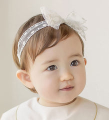 Asphinien baby headband newborn-toddler fit demonstrates one-size elasticity that grows with baby.