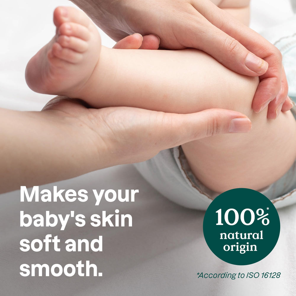 ATTITUDE plastic-free massage oil bar in hand applying gentle, quick-absorb skincare for baby