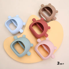 AULEGE bear-glove teether with a fully wrapped design to prevent finger sucking.