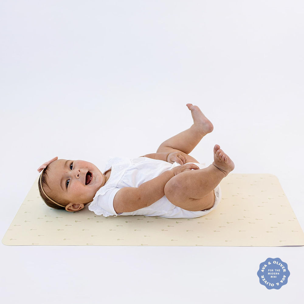 AVA + OLIVER changing mat open palm trees design for at-home or on-the-go use.