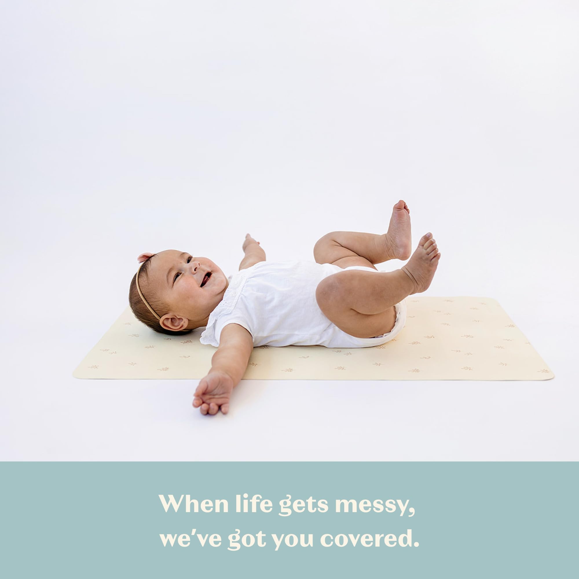AVA + OLIVER portable changing mat tucked in a diaper bag for busy outings.