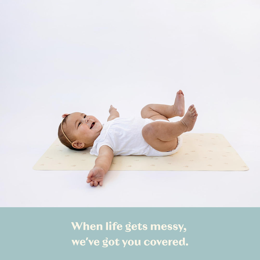AVA + OLIVER portable changing mat tucked in a diaper bag for busy outings.
