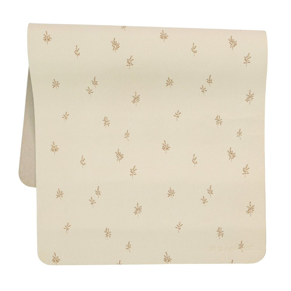 AVA + OLIVER vegan leather changing mat folded in a diaper bag for travel.
