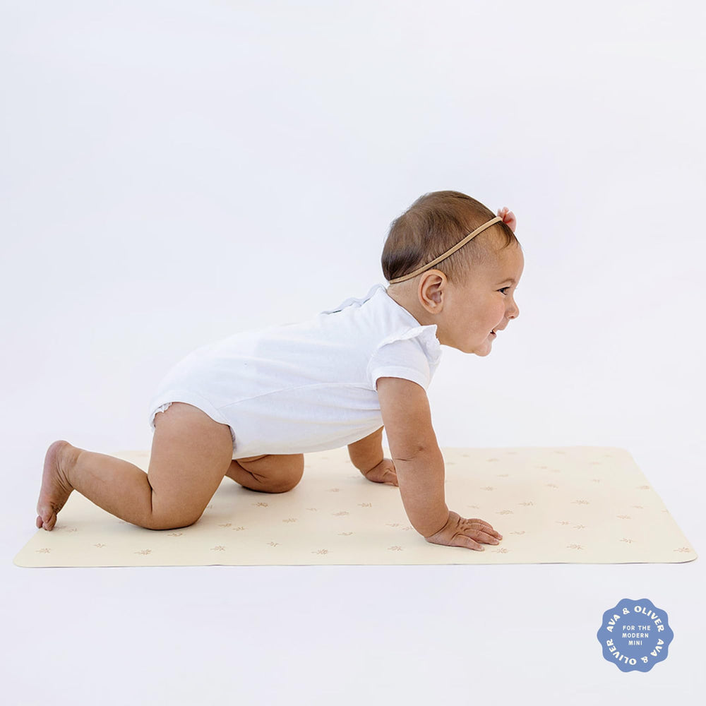 AVA + OLIVER vegan leather changing mat wipes clean easily between diaper changes.