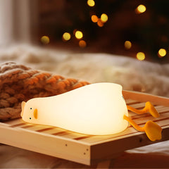 AVACOM squishy duck night light lying flat on a nursery table for a soft, cozy glow.