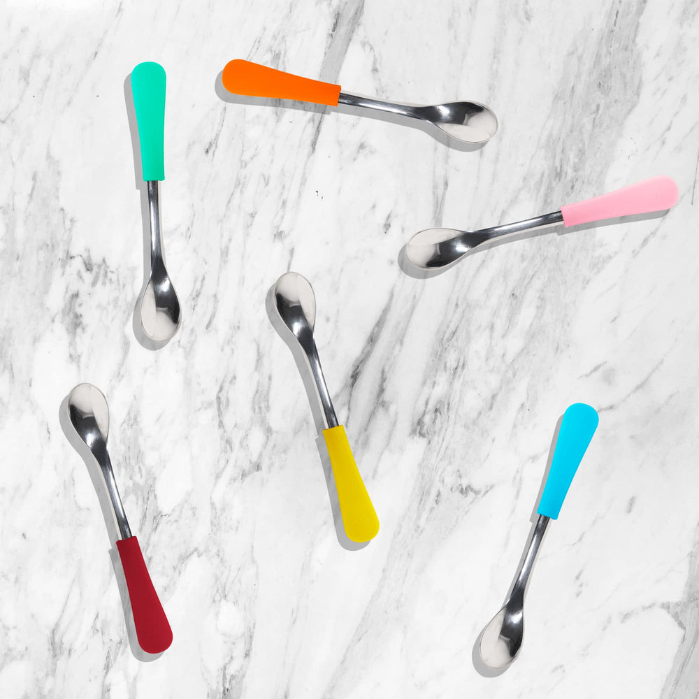 Avanchy pink spoons on dining table highlight cheerful mealtime color.