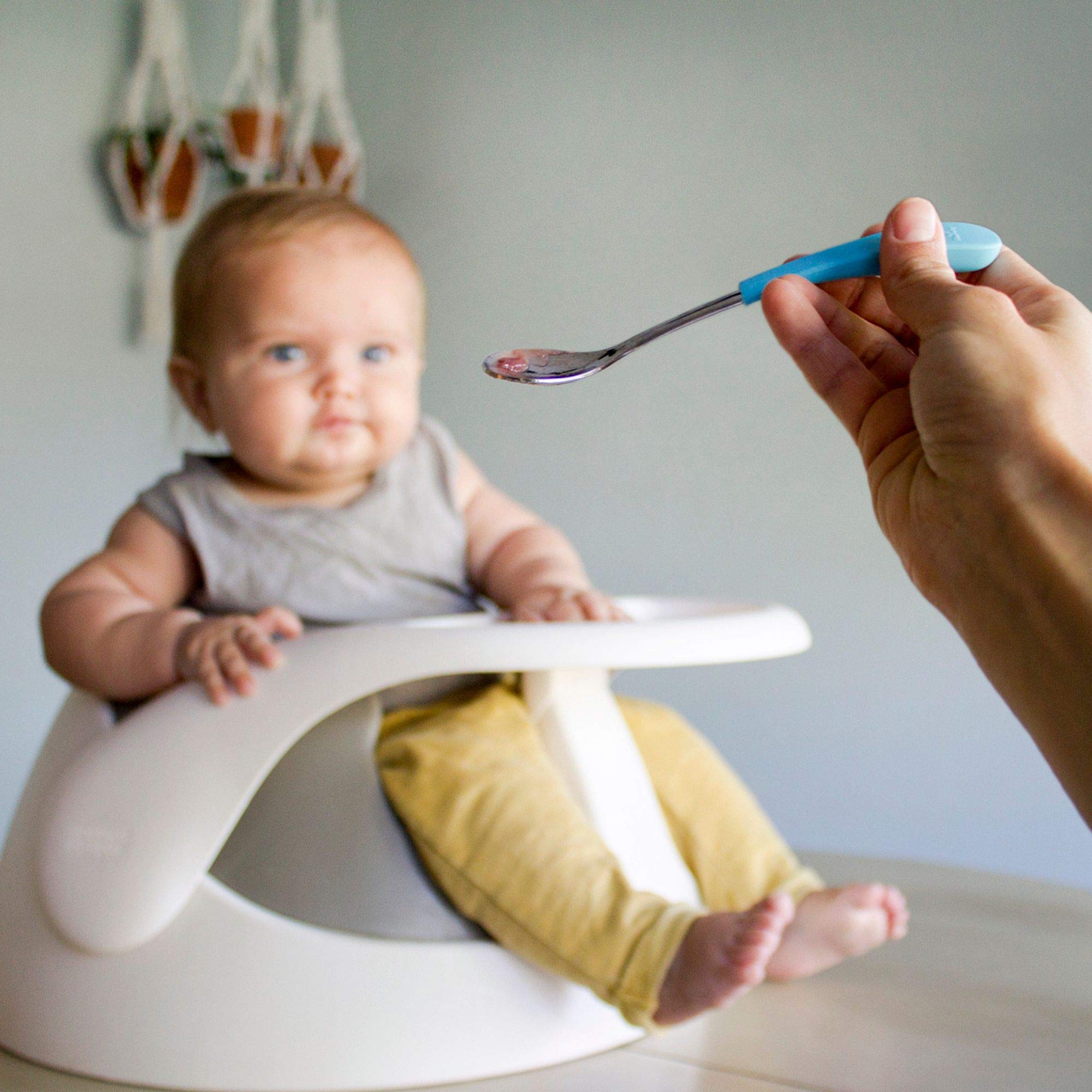 Avanchy self-feeding baby mealtime scene with pink spoons.