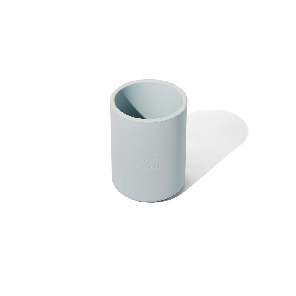 Small hands easily grip the Avanchy training cup for sipping.