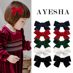 Ayesha Velvet Hair Bows on a toddler's head with secure alligator clip for lasting wear.