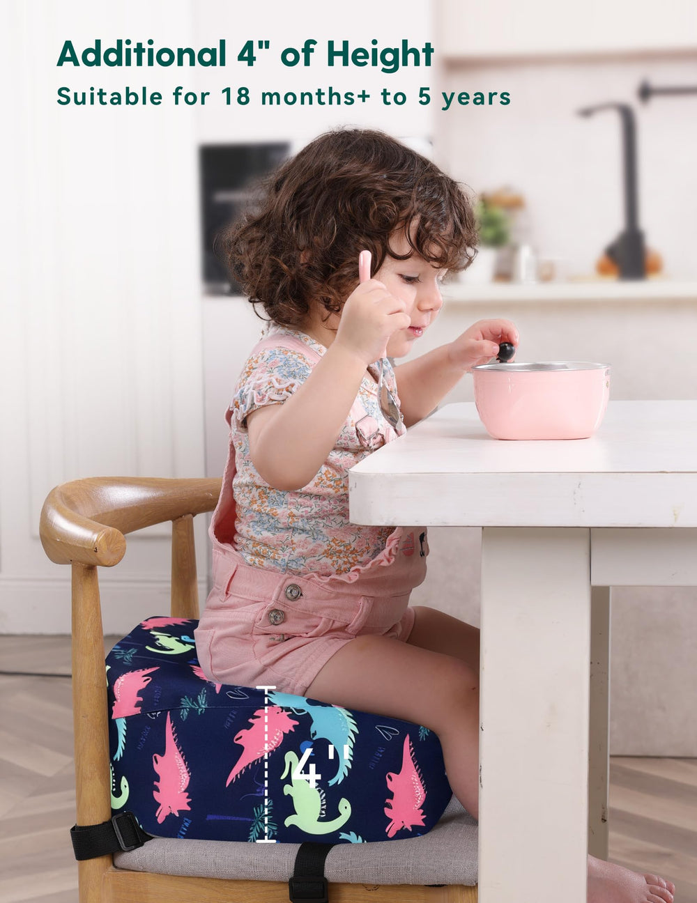 Babelio booster seat on dining table helps kids reach snacks comfortably.