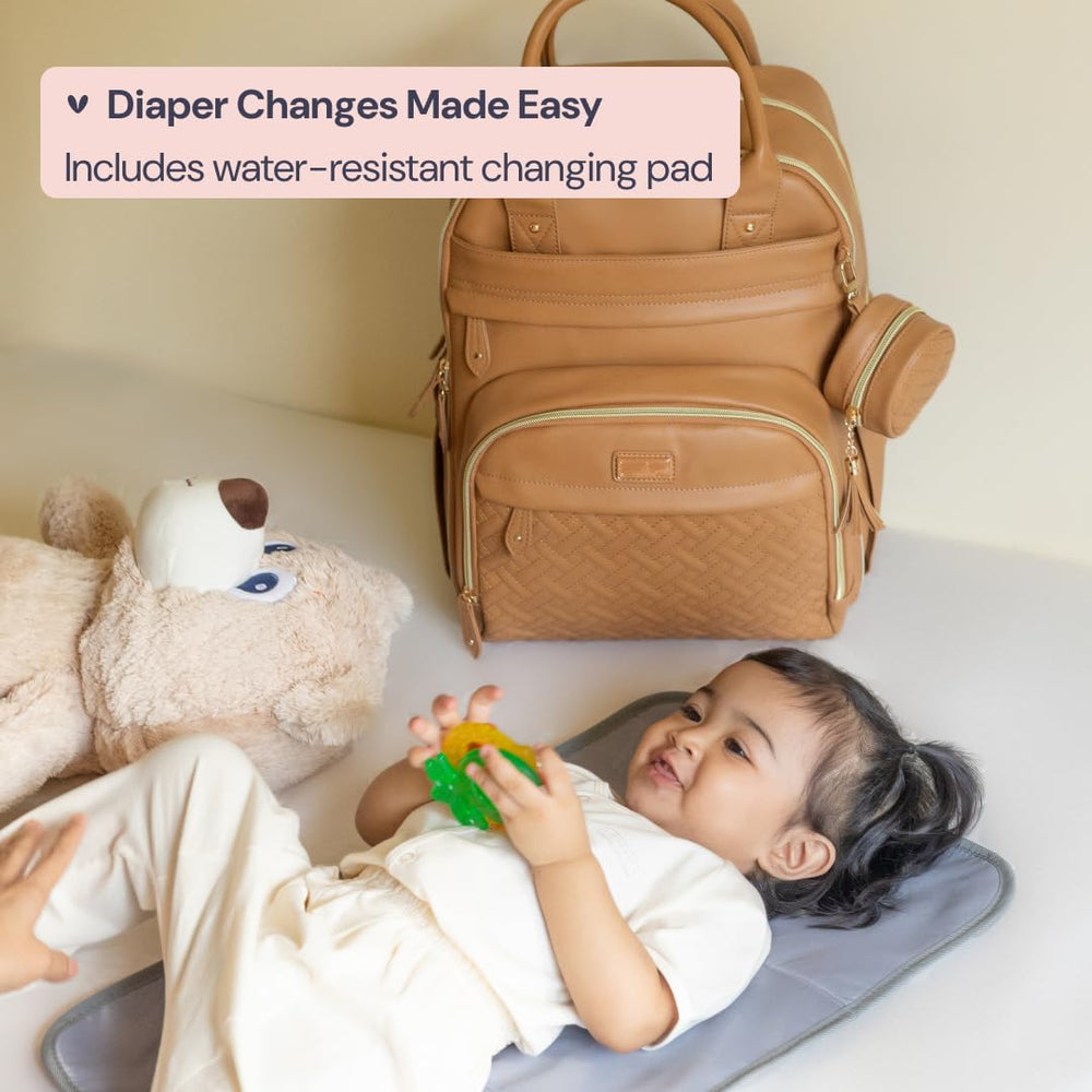 BabbleRoo leather diaper bag backpack close-up shows water-resistant fabric durability.