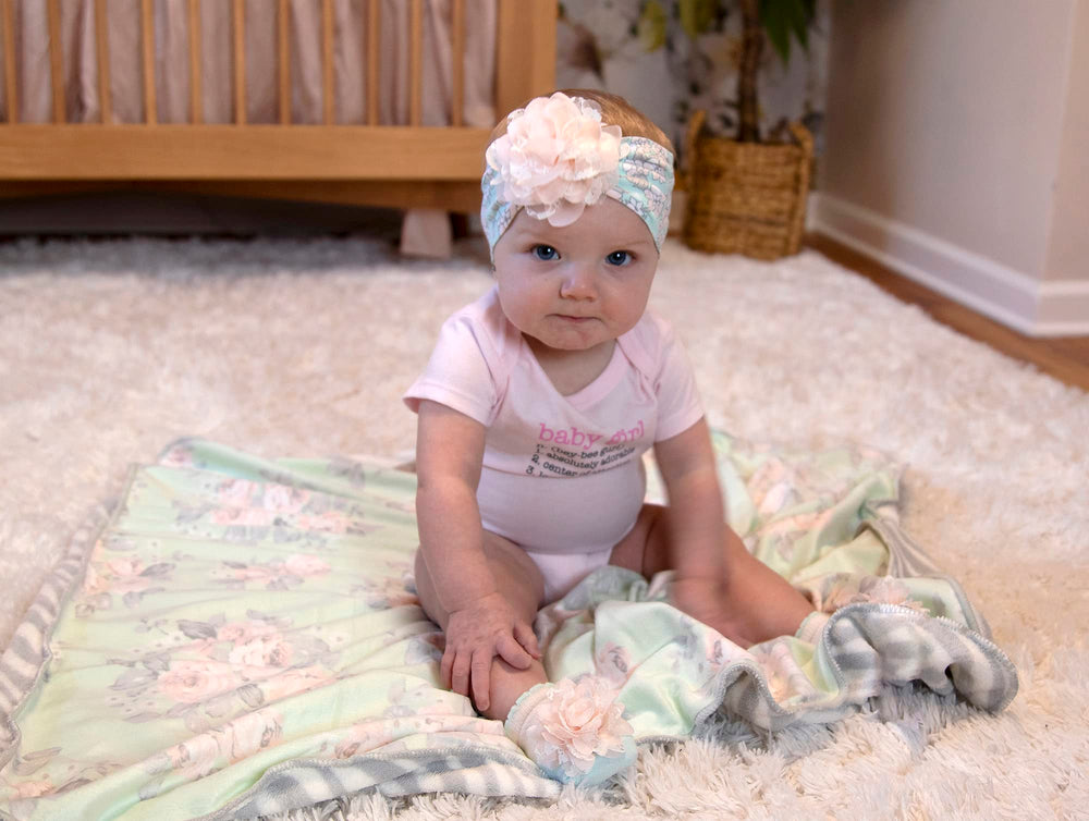 Baby Essentials sherpa blanket used as swaddle or carrier cover.