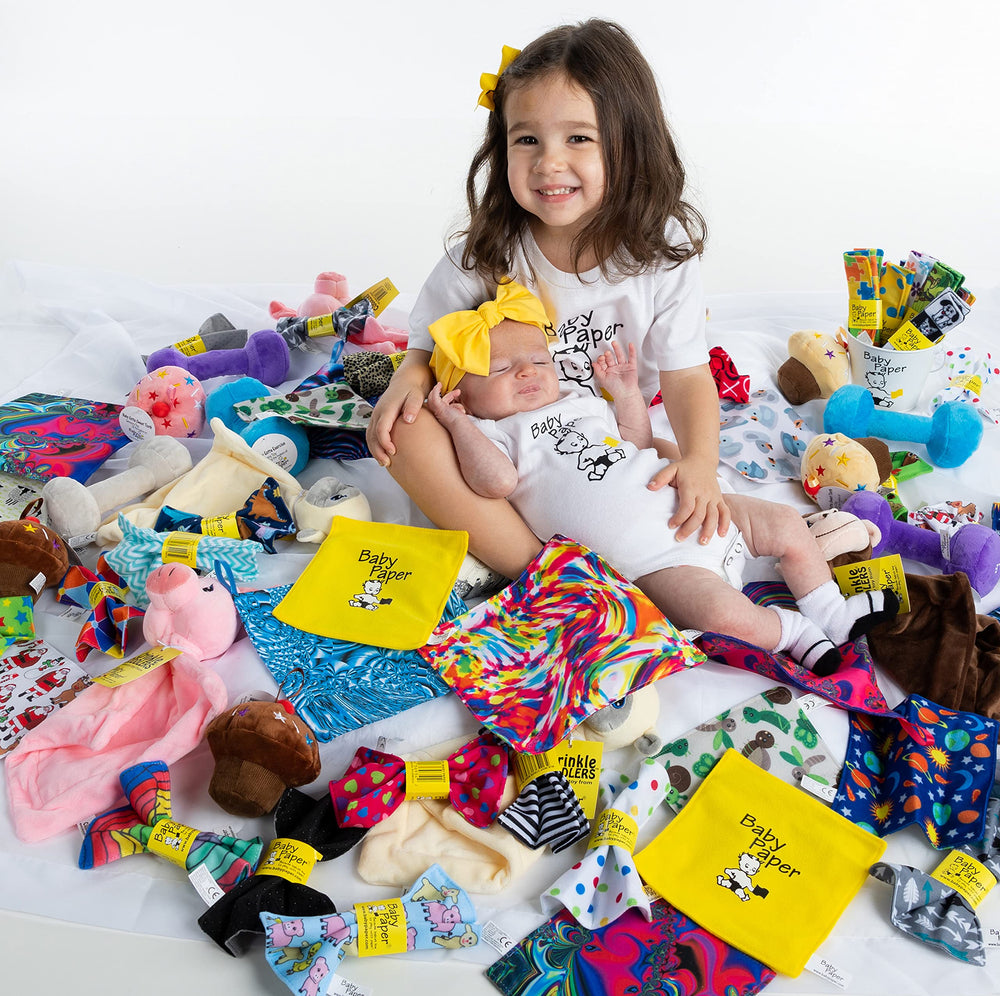 Baby Paper washability and CPSIA-tested non-toxic design shown with fabric loop for easy gifting.