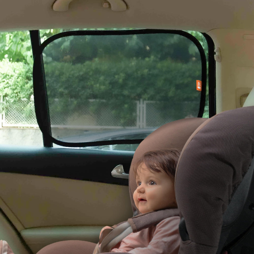 Baby Uma car window shades in use on backseat window for child comfort.