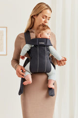 BabyBjörn Baby Carrier Mini back view highlights ergonomic support for growing baby.