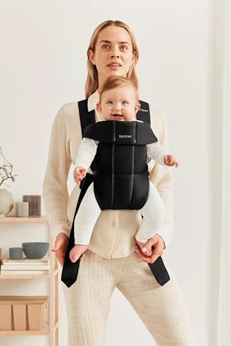 BabyBjörn Baby Carrier Mini worn in-facing-in position demonstrates newborn comfort and closeness.