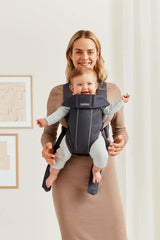 BabyBjörn Baby Carrier Mini newborn position illustration shows natural C-curve support.