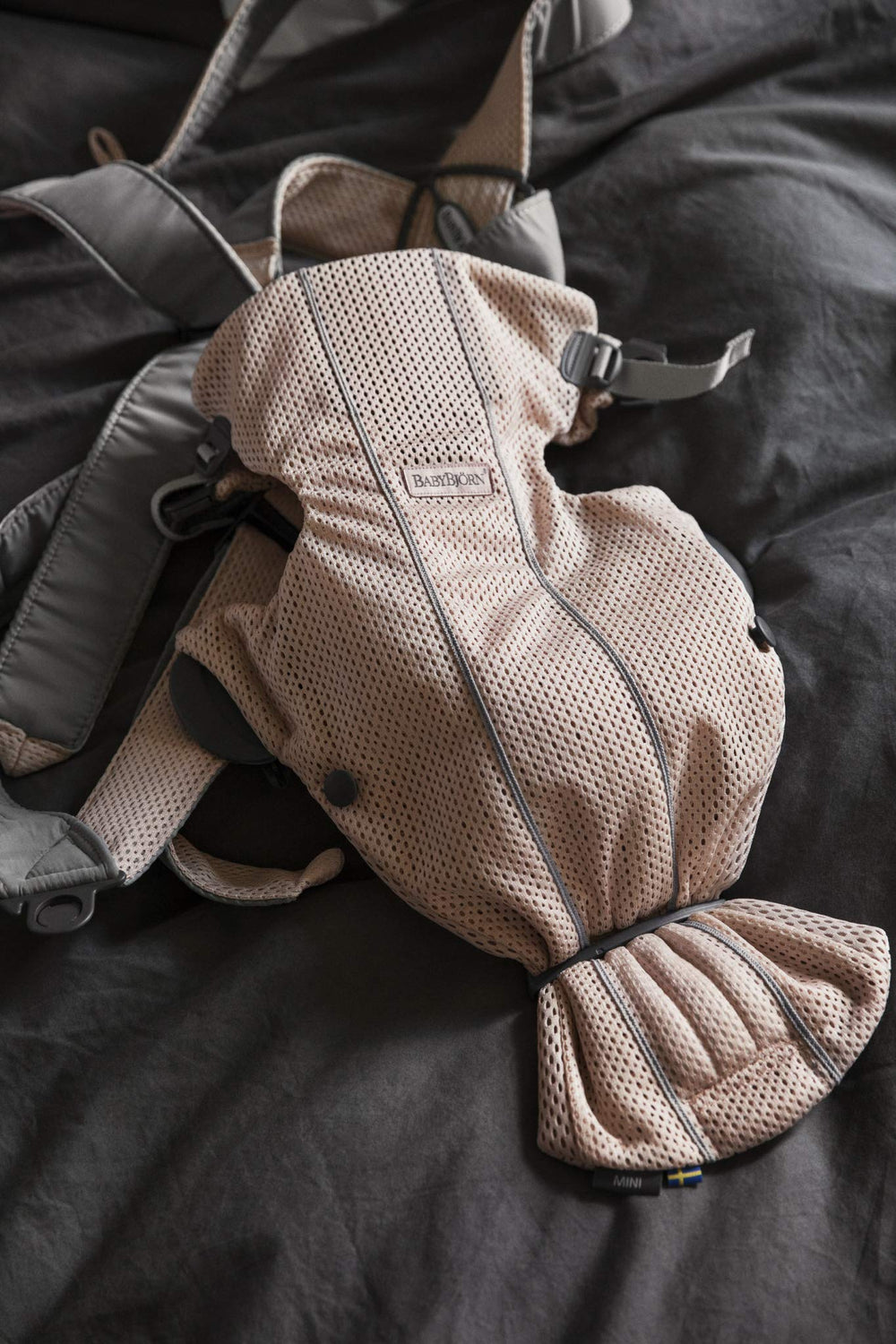 BabyBjörn Baby Carrier Mini worn by a newborn demonstrates ergonomic support and closeness.