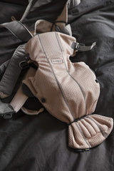 BabyBjörn Baby Carrier Mini worn by a newborn demonstrates ergonomic support and closeness.