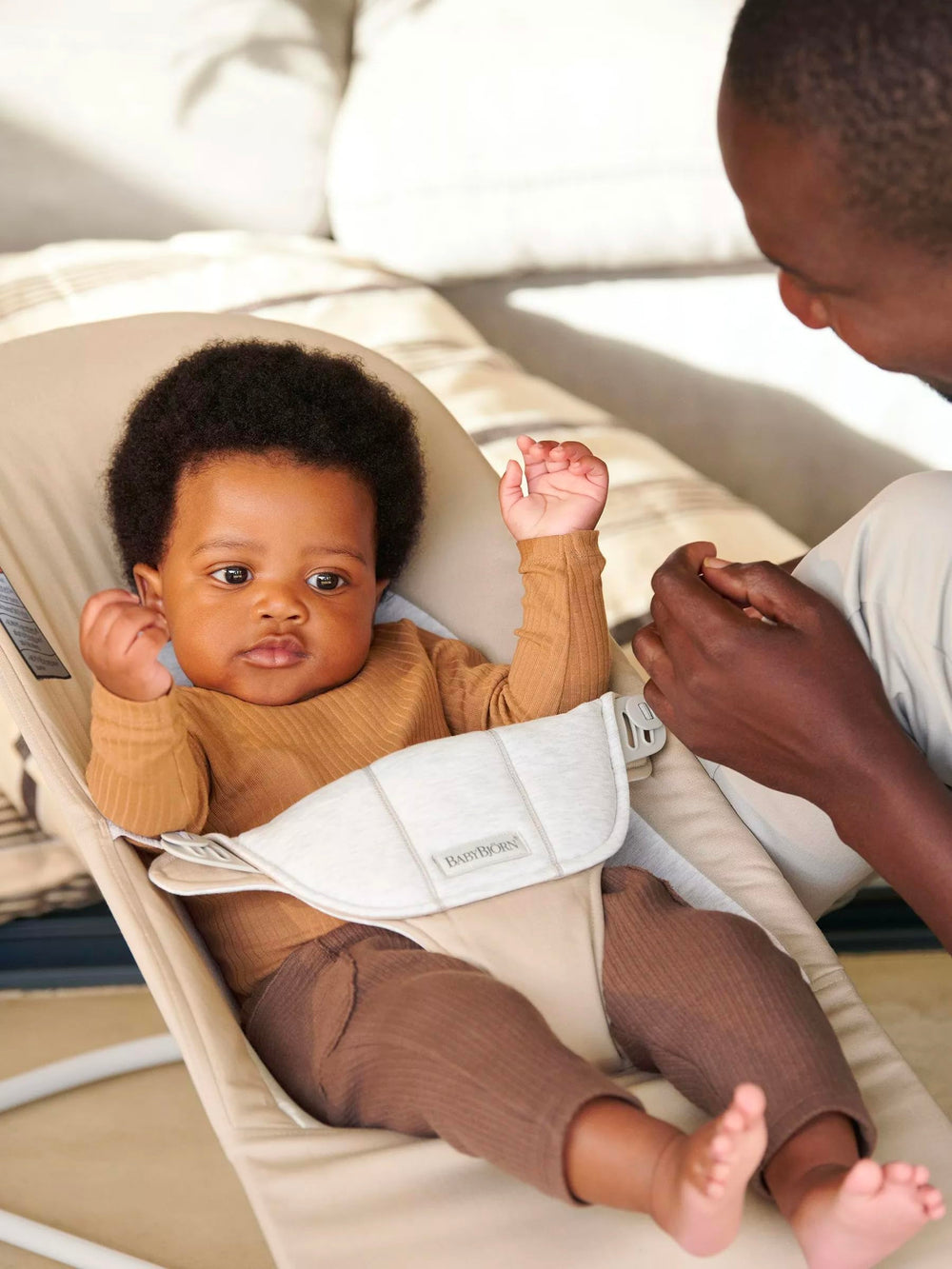 BabyBjörn Bouncer Balance Soft safety harness engaged for secure use.