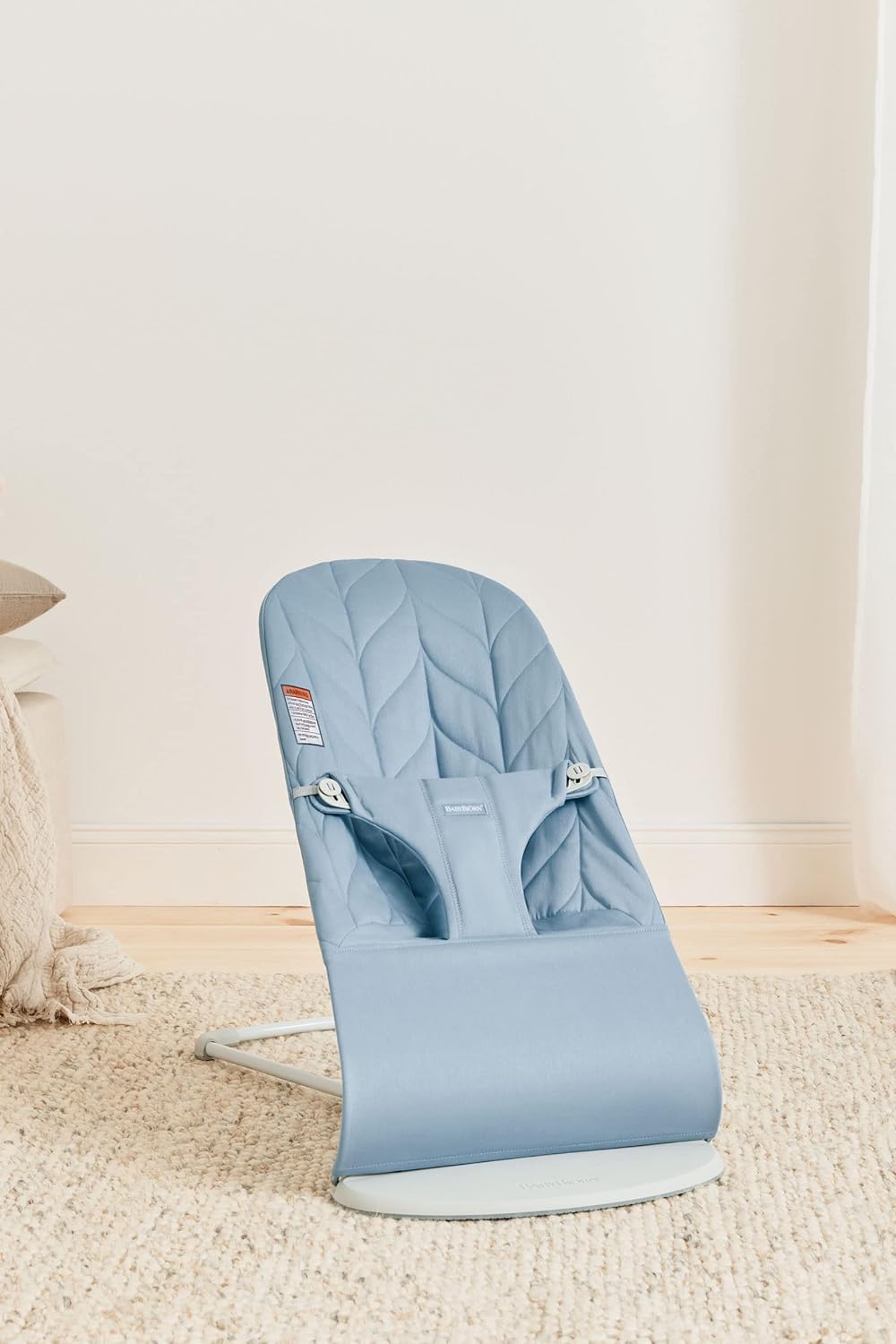 BabyBjörn Bouncer Bliss blue woven in-use with child perched comfortably