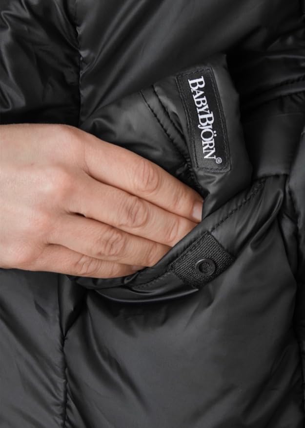 BabyBjörn Winter Cover wind and water-repellent fabric shields baby during outings.