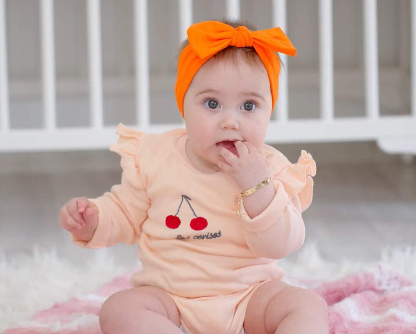 BABYGIZ headband orange-bow during photoshoot to enhance outfits.