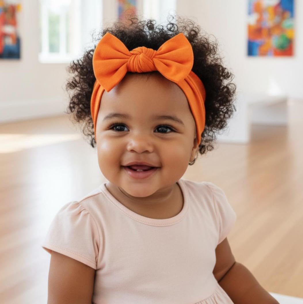 BABYGIZ headband orange-bow worn during playtime keeping hair away from face.