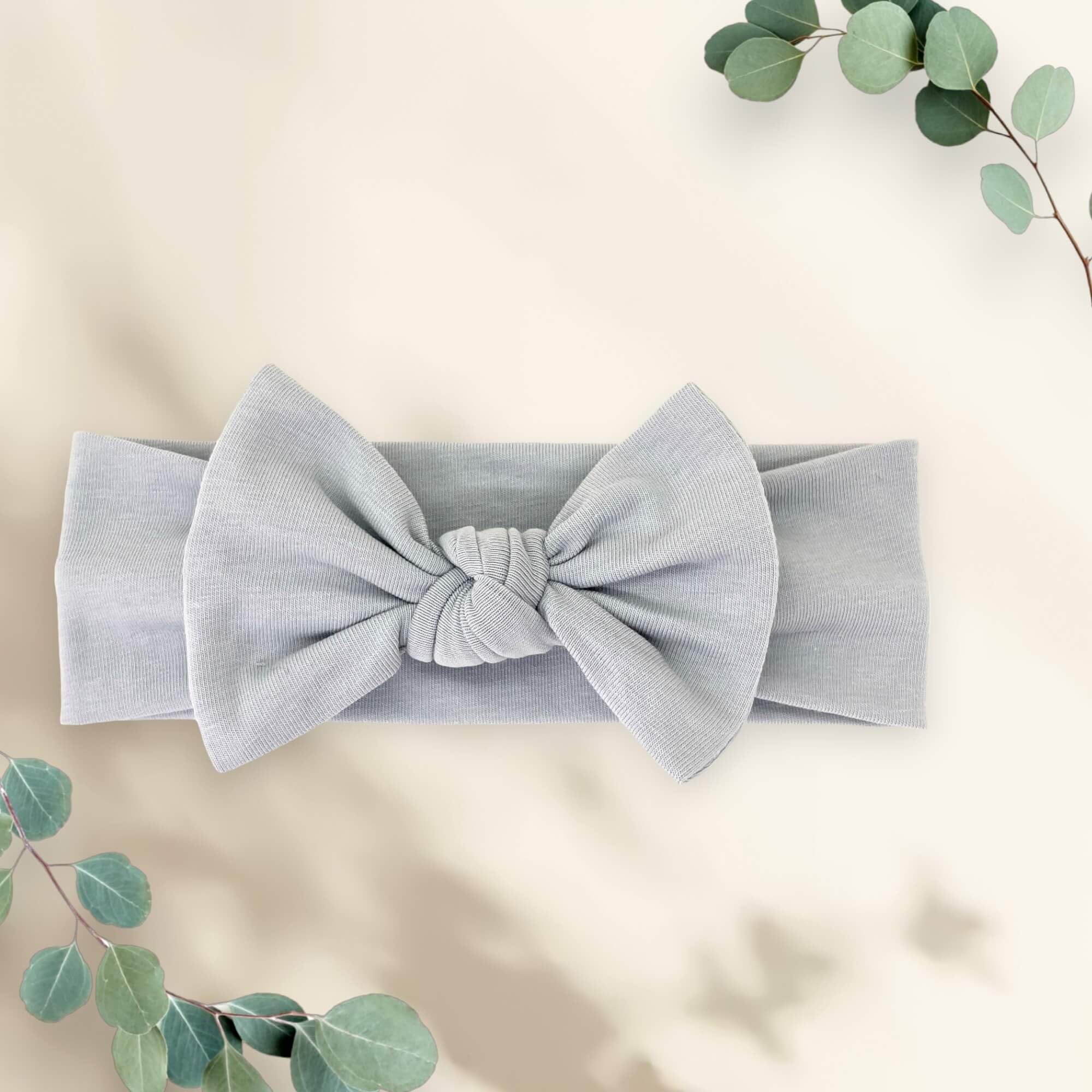 BABYGIZ headband stone gray on baby head with bow detail for easy dressing
