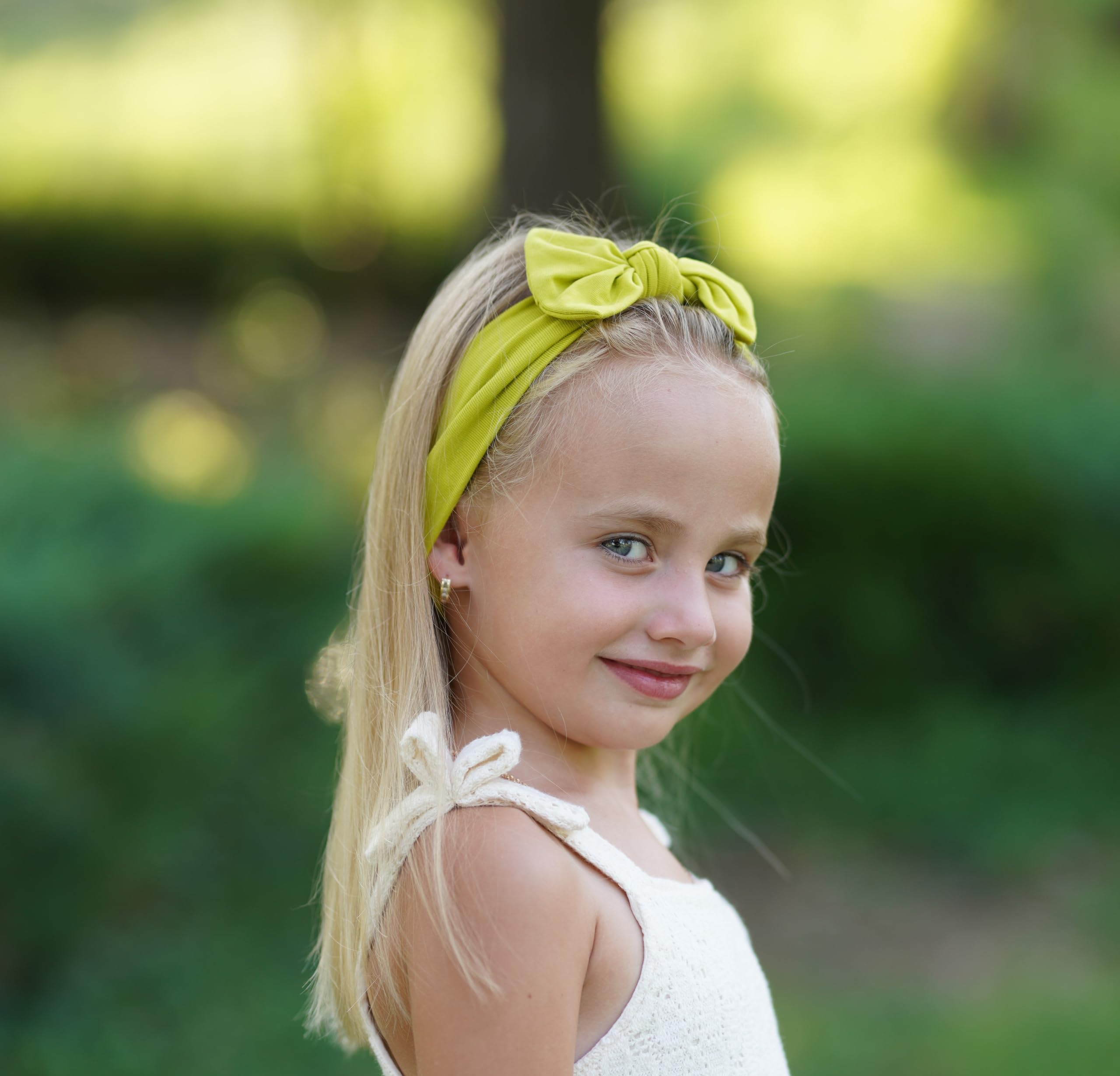 Babygiz toddler headband worn on baby demonstrates secure fit during play.
