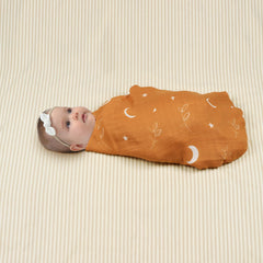 BabyWhale swaddle being wrapped securely to demonstrate snug wrap and versatility