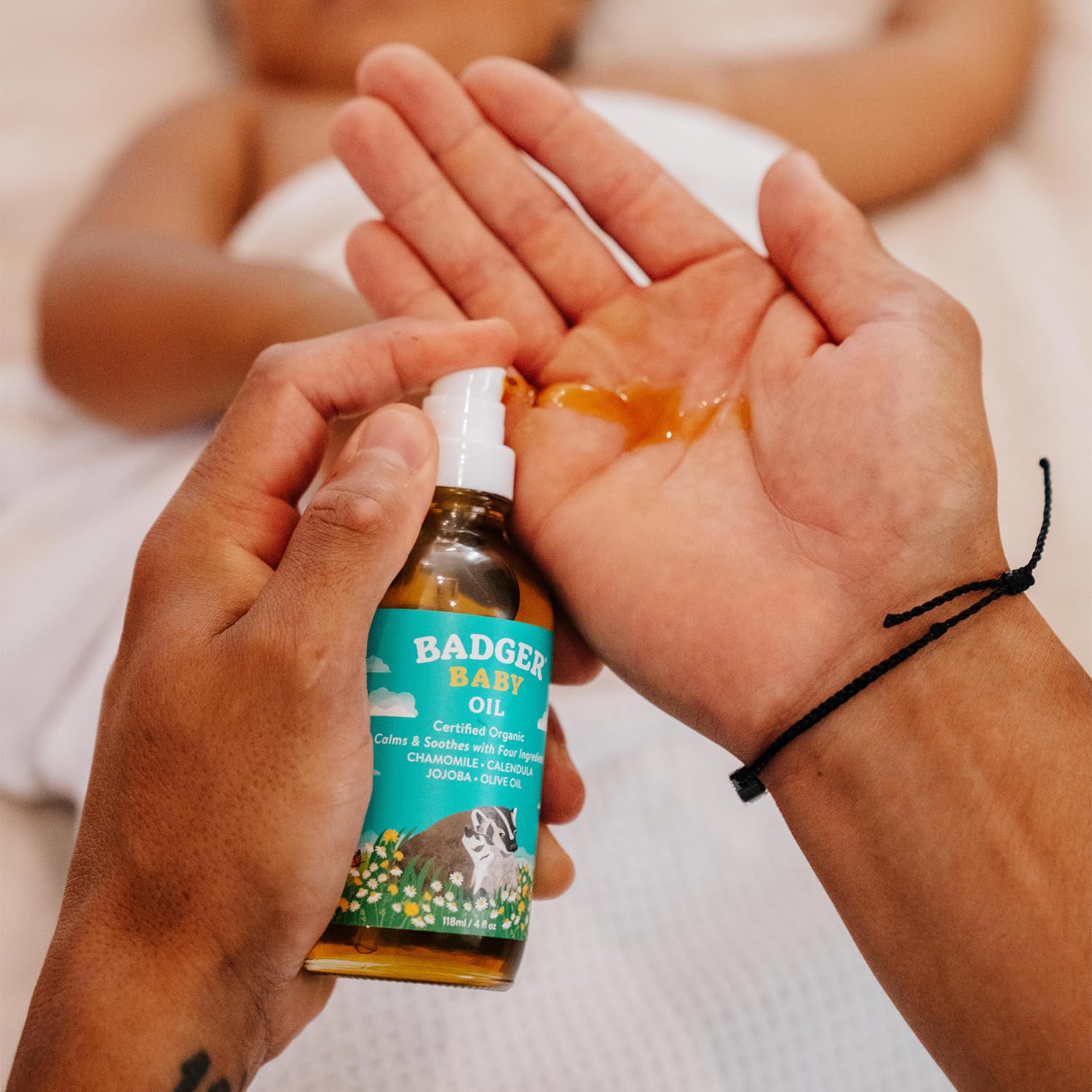 Badger baby oil glass bottle emphasizes clean, recyclable packaging.