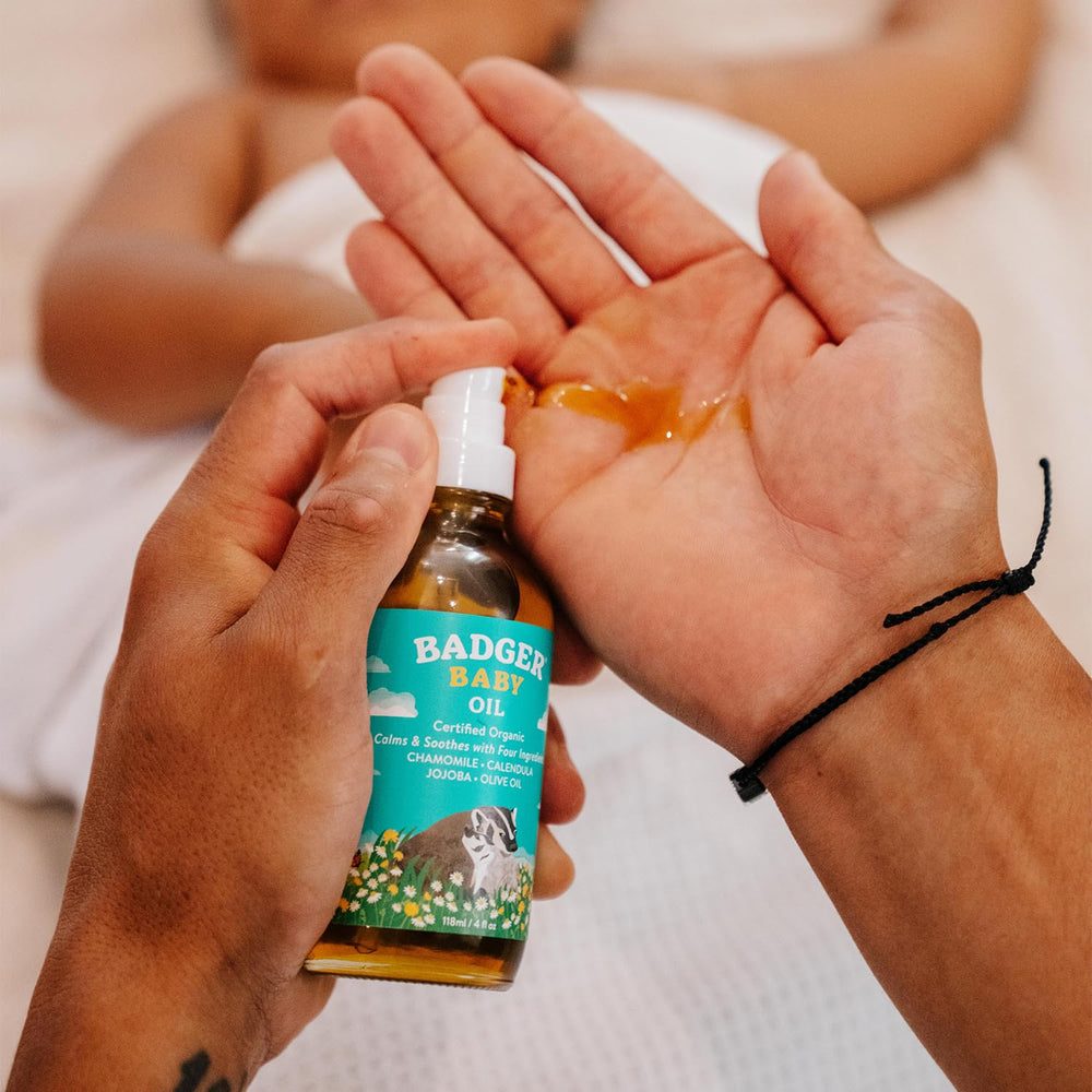 Badger baby oil glass bottle emphasizes clean, recyclable packaging.